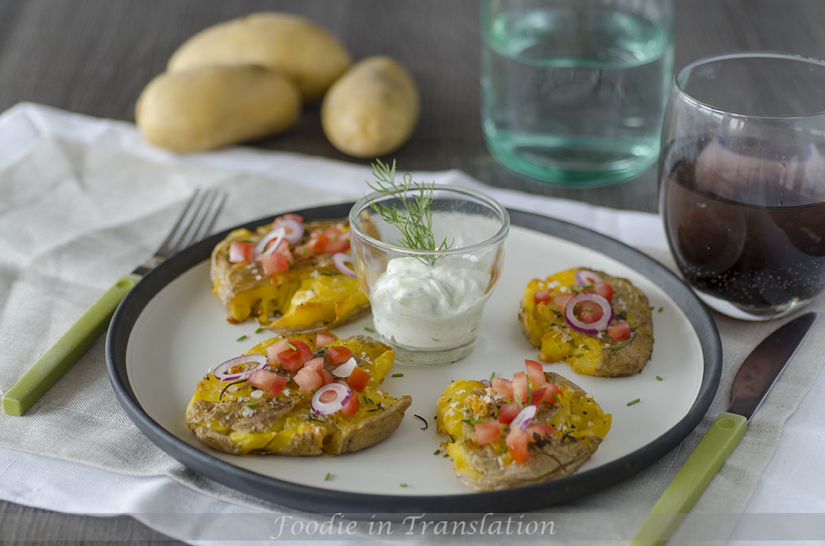 Smashed roasted potatoes with tomato and onion